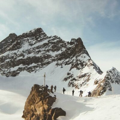 People Walking on Snowy Mountain